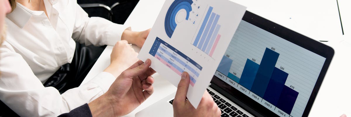 Entrepreneur mapping competitive landscape with strategic framework on a desk