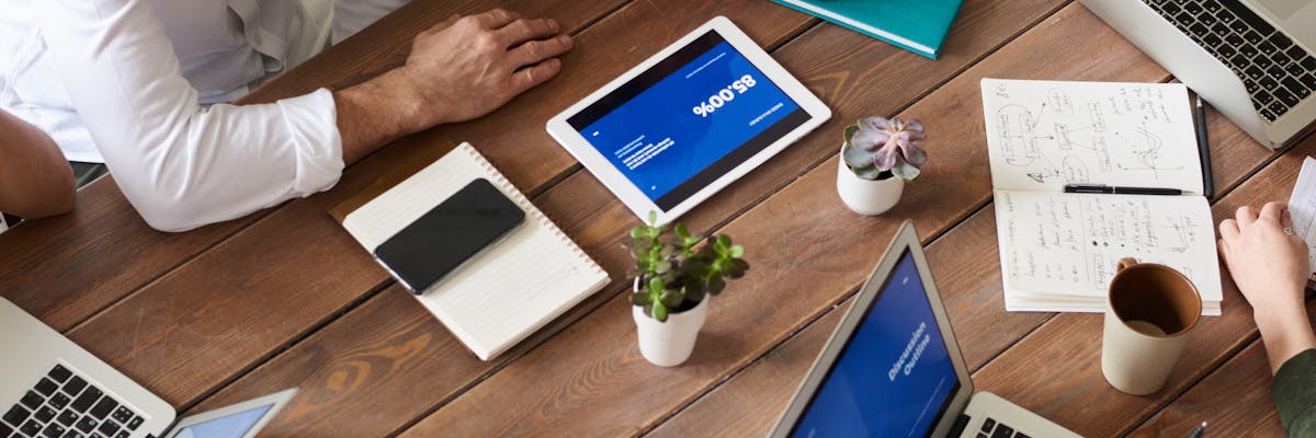 Analyst monitoring multiple competitor websites on a dual-screen setup