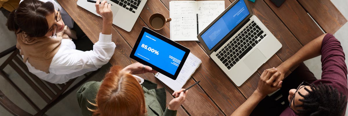 Two professionals reviewing competitor comparison data on a laptop