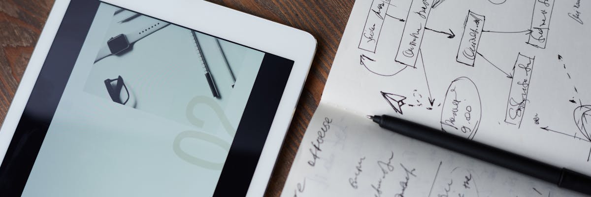 Founder comparing competitor pricing plans on a laptop screen